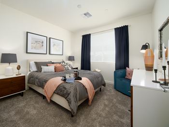 A bedroom with a large bed and a nightstand.